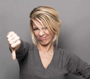 disappointment concept for offended young woman with thumbs down, banner By STUDIO GRAND WEB