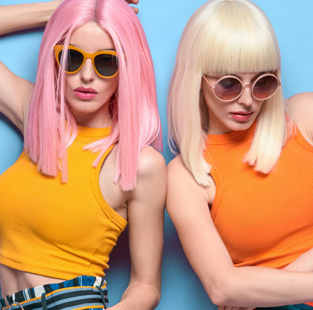 Two Young carefree Woman in stylish sunglasses, striped pants. Beautiful fashionable model girl in trendy summer outfit. Graceful friends with fashion ... See More By evgenij918