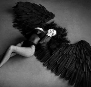 Fallen black angel with wings. Sexual woman By Elina Leonova