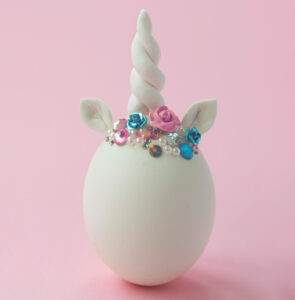 Single white egg, with unicorn decoration; Creative minimal Easter background By hiddencatch