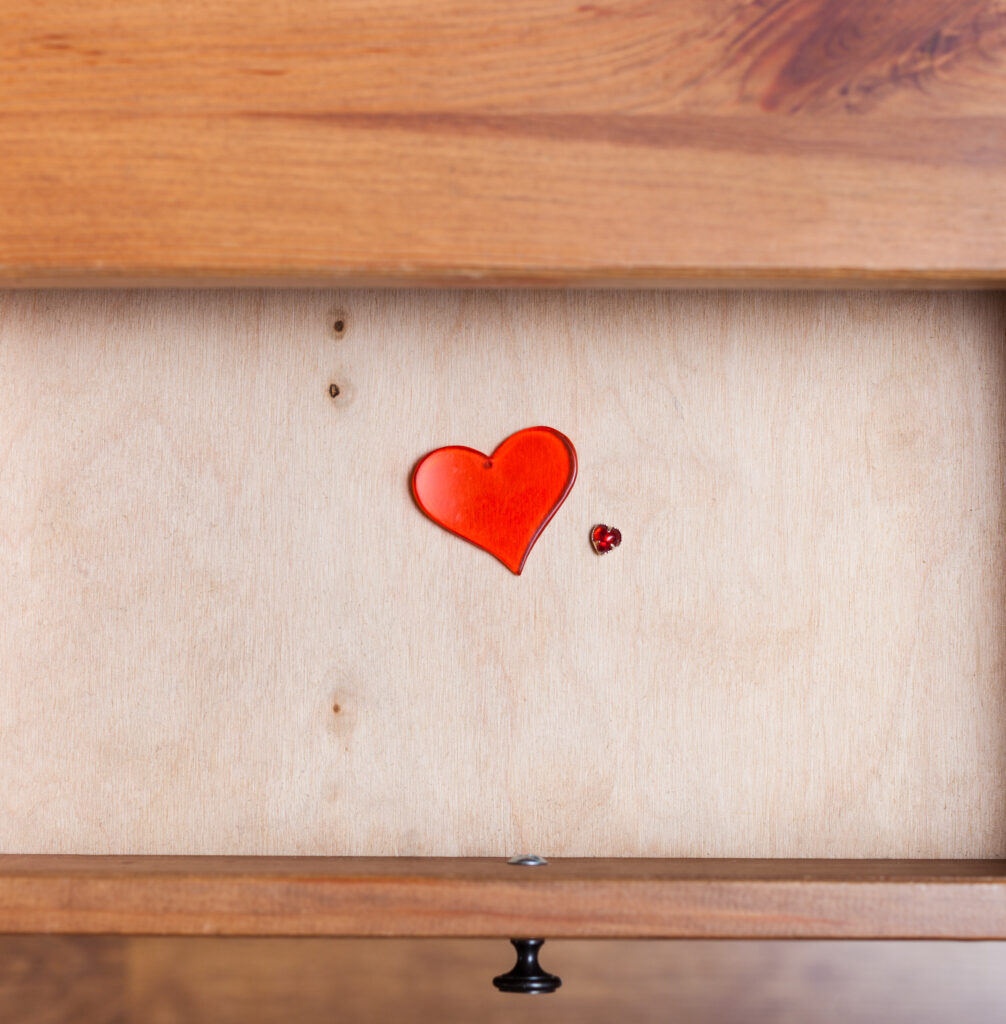two red glass hearts in open drawer By vvoe